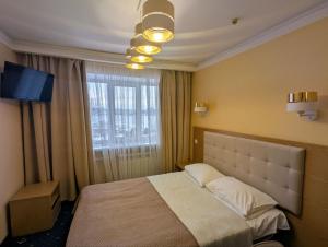 Postel nebo postele na pokoji v ubytování Hotel Ternopil