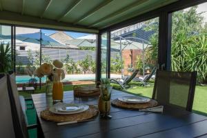 a table with plates and glasses on top of it at Villa Verde Royal in Kaštela