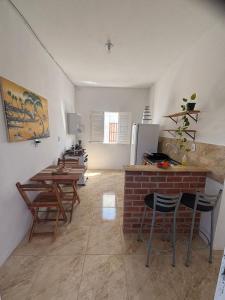 a kitchen with tables and chairs in a room at Refúgio da Major in Aracati +15 photos