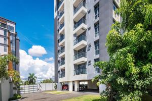an apartment building with trees in front of it at Parkhurst 408 With King Bed and Pool in Kingston