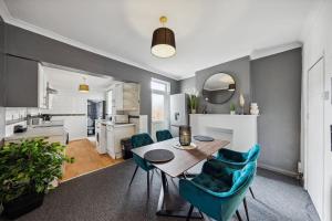 a kitchen and dining room with a table and chairs at Comfy Home 5 Minutes Walk From Medway Hospital in Gillingham