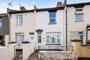 an old house with a gate in front of it at Comfy Home 5 Minutes Walk From Medway Hospital in Gillingham