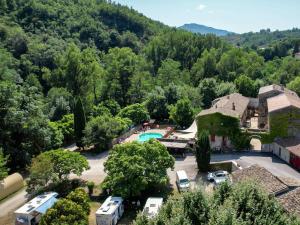 an aerial view of a resort with a pool and trees at Le Moulin D'onclaire Camping et chambres d'hôtes in Coux