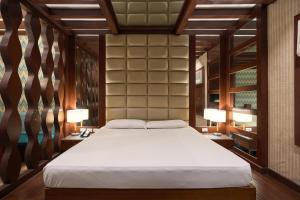 a bedroom with a large bed and two lamps at Victoria Court Malabon in Manila