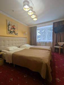 Postel nebo postele na pokoji v ubytování Hotel Ternopil