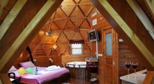 a room with a bed in a wooden cabin at כיפת השמיים - בריכה פרטית in Giv'at Yo'av