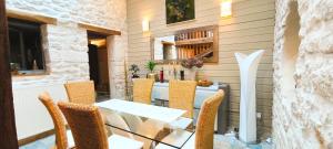 a dining room with a glass table and chairs at House 10 people, heated pool, countryside in Marthon