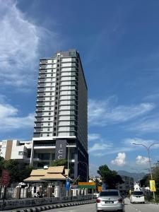 a tall building with cars parked in front of it at ICC Luxury Suites Ipoh City Centre By Landmark in Ipoh
