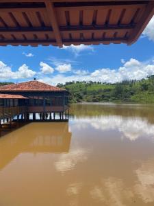 a large body of water with a building on it at Hotel Fazenda e Pesqueiro Pousada da Serra in Goianésia