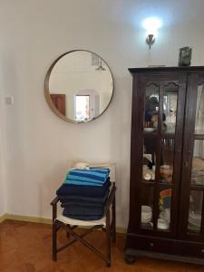a room with a mirror and a chair and a cabinet at Beach Kaz in Takamaka +65 photos