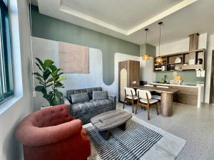 a living room with a couch and a table at Meridian apartment service at Marina Long beach Phu Quoc in Phú Quốc