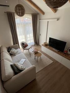 a living room with a couch and a flat screen tv at Guest house TAK in Cetinje