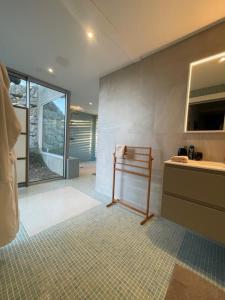 a bathroom with a sink and a towel rack at La Beaume in Blauvac