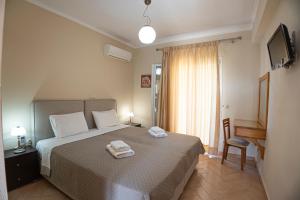 a bedroom with a bed with two towels on it at Villa Agrilida in Vasiliki +133 photos