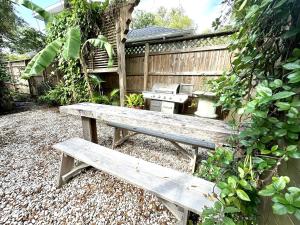 a wooden bench sitting in front of a fence at Lemon Street Retreat Renovated 1920 Craftman ,Half mile Stroll to Historic DT ,Beaches 3 mi to Vilano & 5 to St Aug in Saint Augustine