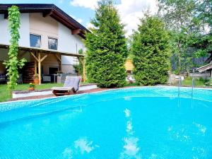 a swimming pool in front of a house at Schernhof Hoamatzeit - Tiroler Bauernhof in Söll