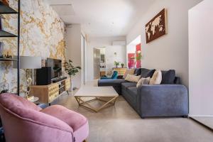 a living room with two couches and a tv at Maison de Charme en Provence avec jardin et piscine in Carpentras
