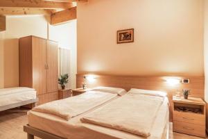 Postel nebo postele na pokoji v ubytování Hotel Garnì Maria
