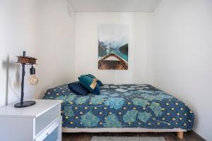a bedroom with a bed with a blue comforter at Maison de Charme en Provence avec jardin et piscine in Carpentras +15 photos