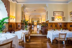 a dining room with white tables and chairs at Bettoja Hotel Massimo d'Azeglio in Rome