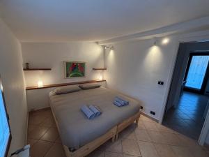 a bedroom with a bed with two pillows on it at La Mansardina in Chioggia