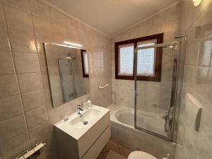 a bathroom with a sink and a toilet and a tub at La Mansardina in Chioggia +2 photos