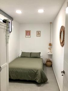 a bedroom with a bed in a white room at La Casilla del Molino in Almodóvar del Río
