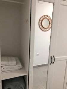 a bathroom with a mirror and a closet at La Casilla del Molino in Almodóvar del Río