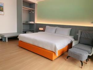 Postel nebo postele na pokoji v ubytování Orange Homestay