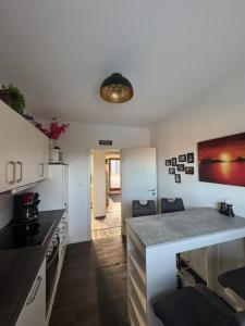 a kitchen with white cabinets and a counter top at Gemütliche Ostsee Oase, 3 Zimmer mit Balkon in Bad Schwartau in Bad Schwartau