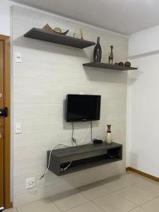 a living room with a tv on a wall at Top Flat confortavel e muito bem localizado in Brasília
