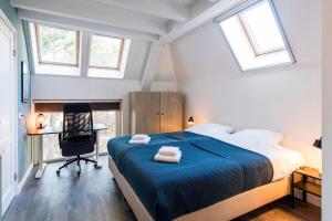 a bedroom with a bed and a desk and windows at Bosch (10p) in Buren +28 photos