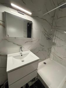 a white bathroom with a sink and a shower at Boston - Loft with Jacuzzi in Sanary-sur-Mer +27 photos
