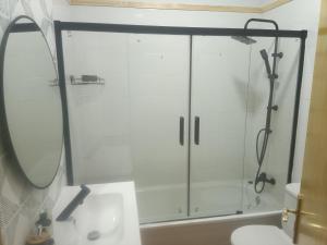 a shower with a glass door in a bathroom at La Casa del Mar in Barbate