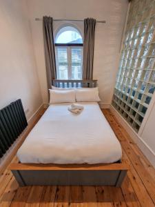 a large bed in a room with a window at City Centre Manchester Apt by City SuperHost in Manchester