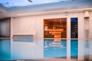 a house with a swimming pool in front of it at Vila Borova Wellness&SPA Resort in Zlatibor