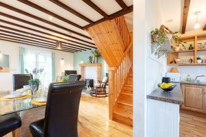 a kitchen and living room with a table and chairs at Cute cottage for short getaway in Cross Mahon