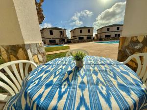 a blue and white table with a potted plant on it at Apartamento con piscina - Posta de sol in Cala en Forcat