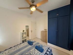 a bedroom with a bed with two blue pillows on it at Apartamento con piscina - Posta de sol in Cala en Forcat +16 photos