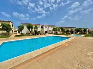 a swimming pool in front of a house at Apartamento con piscina - Posta de sol in Cala en Forcat