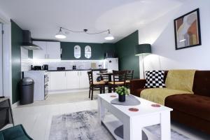 a living room and kitchen with a couch and a table at listing SALE - Entire Town Centre Apartment Free Parking WiFi in Colchester