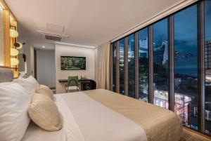 A bed or beds in a room at LIN Boutique Hotel by HOUSY HOST