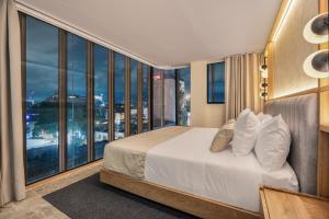 A bed or beds in a room at LIN Boutique Hotel by HOUSY HOST