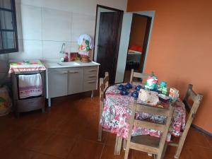 a kitchen with a table with chairs and a sink at Casa Aconchego das Andorinhas in Ouro Preto