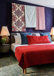 a bedroom with a bed with colorful pillows and blankets at Maison Boissière BARNES Residences in Paris