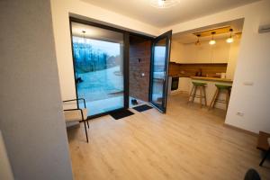 a kitchen and living room with a large glass door at EcoTravel New in Suceava +27 photos