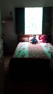 a small child laying on a bed in a bedroom at Aconchegante e familiar in Marituba +3 photos