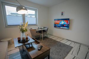 a living room with a table and a tv at Feel like Home 1 in Biberach an der Riß