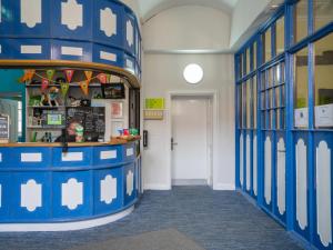 a classroom with blue and white walls and a door at YHA Whitby in Whitby