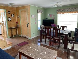 a living room with a table and a dining room at Los Queltehues in Puerto Montt